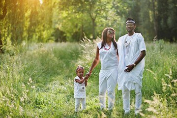 african-american-family-white-nigerian-national-dress-having-fun-outdoor_627829-3621.jpg