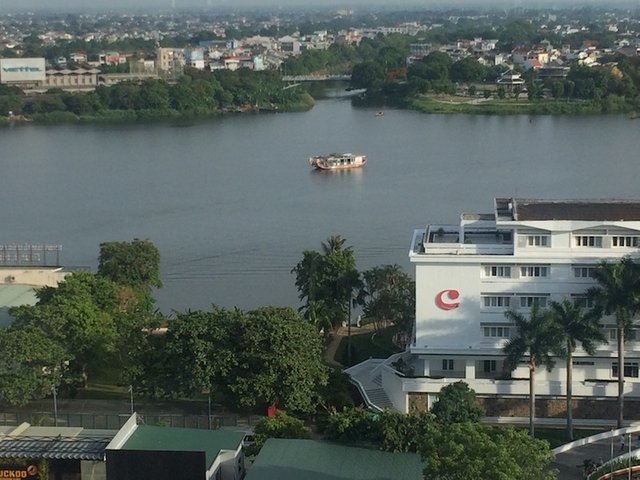 A tour boat on the Perfume River, viewed from the hotel restaurant.jpg