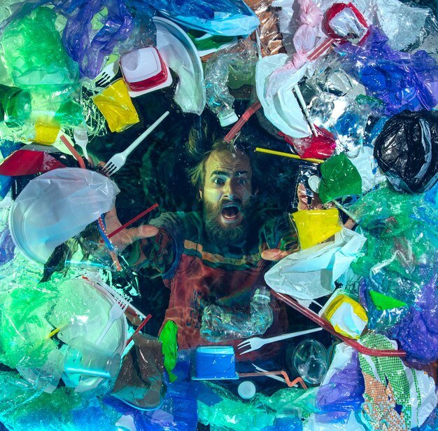 man-drowning-water-plastic-recipients-pile-garbage-ecology-environment-concept_155003-41819.jpg