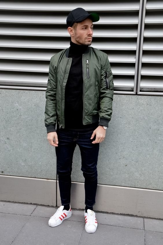 Green-Bomber-Jacket-styled-with-Black-Sweater-Denim-Jeans-and-round-off-this-look-by-wearing-White-Sneakers-1.jpg