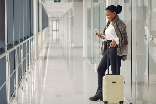 black-woman-with-suitcase-airport_1157-33364.jpg