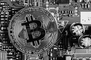 93062565-golden-bitcoin-cryptocurrency-on-computer-circuit-board-macro-shot.jpg