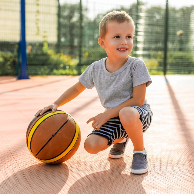 happy-boy-playing-basketball-outdoors.jpg