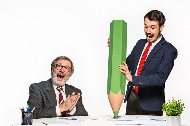 two-colleagues-working-together-office-with-huge-giant-pencil_155003-2502.jpg