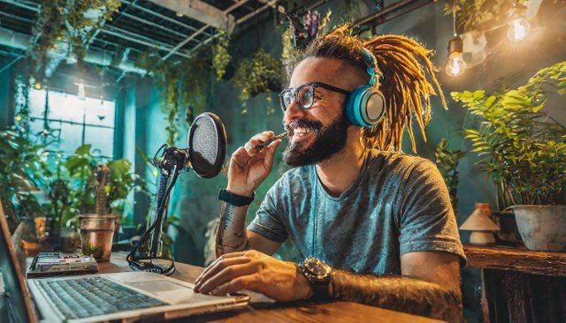 Firefly hipster white male with dreads sitting at a podcast desk mic on boom smoking a joint in ston (2).jpg
