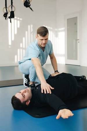 free-photo-of-physiotherapist-crouching-over-exercising-patient.jpeg