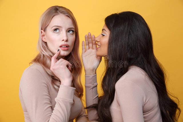 concentrated-young-two-ladies-talking-each-other-photo-standing-over-yellow-background-looking-aside-91801291.jpg