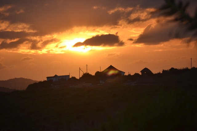 sunset over the village from the kraal.JPG