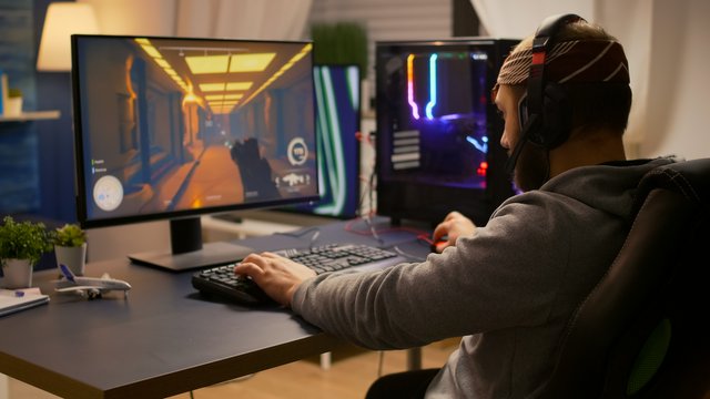 videogamer-winning-first-person-shooter-tournament-using-rgb-keyboard-professional-headphones-pro-player-man-talking-with-other-players-online-game-competition-powerful-computer.jpg