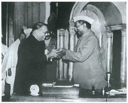 Dr._Babasaheb_Ambedkar,_chairman_of_the_Drafting_Committee,_presenting_the_final_draft_of_the_Indian_Constitution_to_Dr_Rajendra_Prasad_on_25_November,_1949.jpg