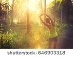 stock-photo-young-female-runner-stretching-arms-before-running-at-morning-forest-trail-646903318.jpg