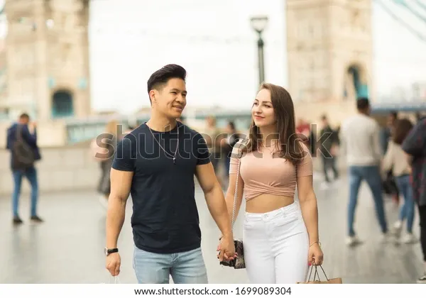 young-couple-walking-together-by-600w-1699089304.webp