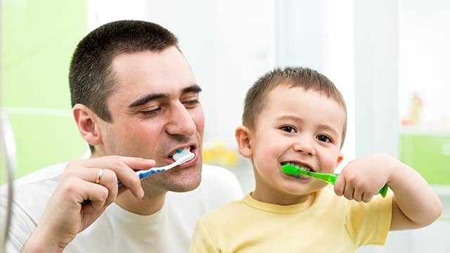 father-kid-son-brushing-teeth-bathroom.jpg