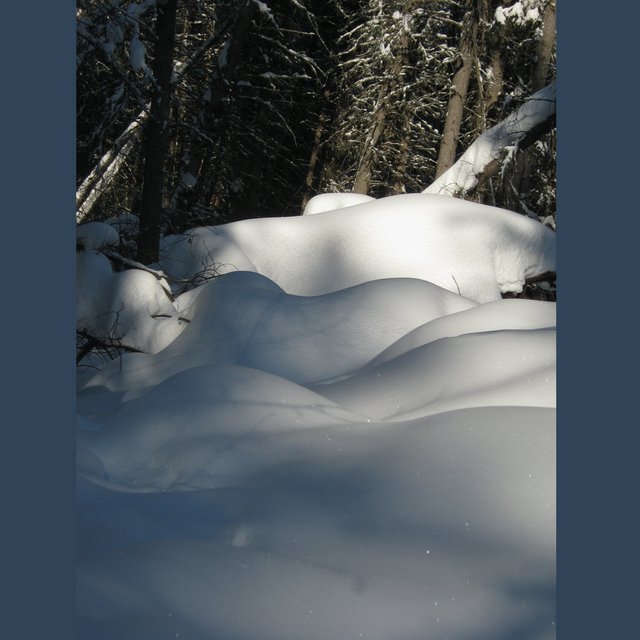 waves of snow in opening across from welll house.JPG
