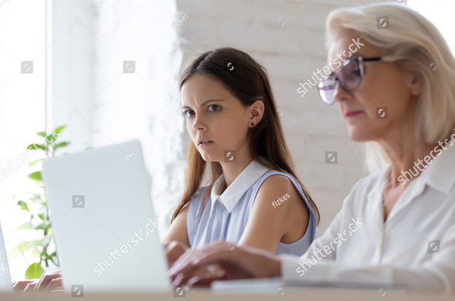 stock-photo-surprised-young-woman-worker-sit-at-office-desk-work-near-coworker-feel-stunned-amazed-looking-at-1498236317~2.jpg