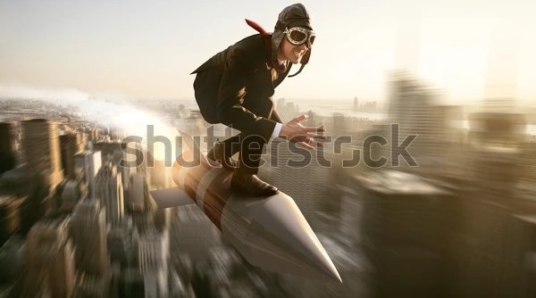 man-on-rocket-above-new-600w-704186779_1.webp