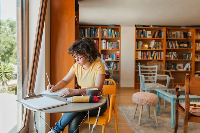 teen-girl-writing-notebook-near-window1.jpg