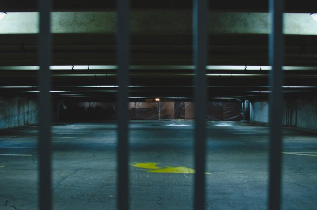 Under the parking garage behind bars.JPG