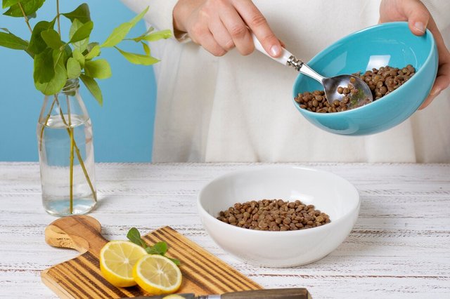 close-up-hand-holding-bowl-with-lentils_23-2149080552.jpg