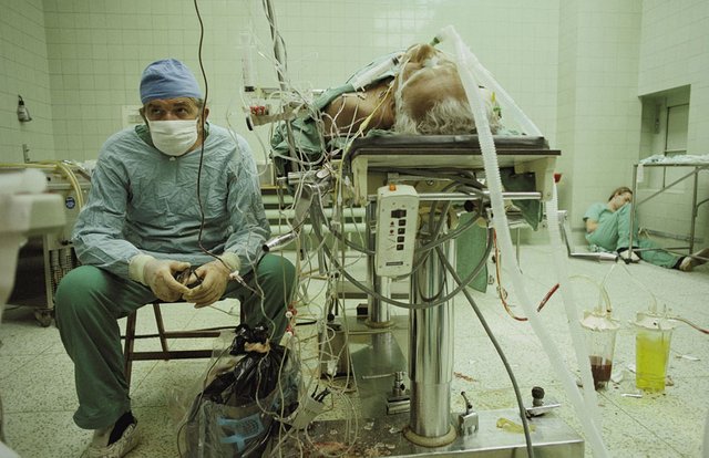 3. Heart surgeon after 23-hour-long (successful) heart transplant. His assistant is sleeping in the corner..jpg