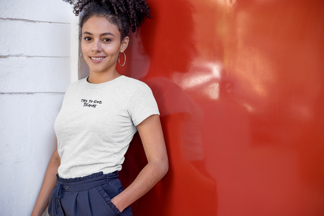 heather-t-shirt-mockup-of-a-kinky-haired-woman-leaning-on-a-red-metal-door-23965.png