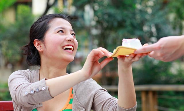 happy-young-woman-share-cake-with-friend.jpg