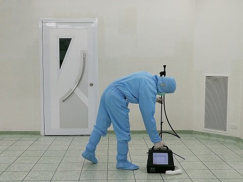 inspector testing indoor air in hazmat suit.jpeg