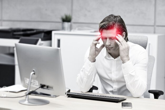 close-up-portrait-businessman-with-headache-workplace_470178-116.jpg