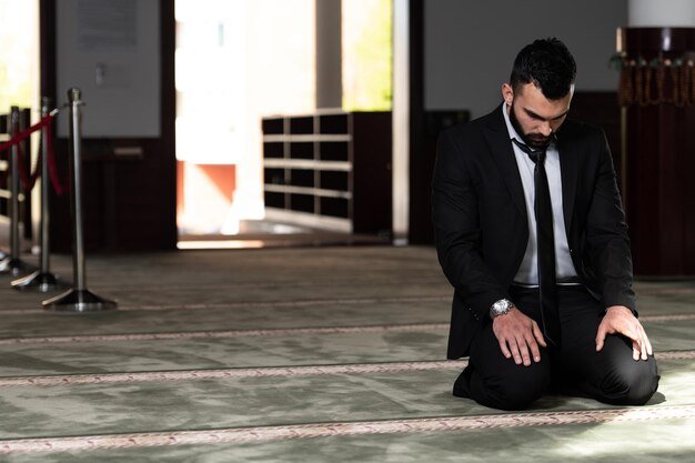 businessman-muslim-making-traditional-prayer-god-allah-mosque_600776-26964.jpg