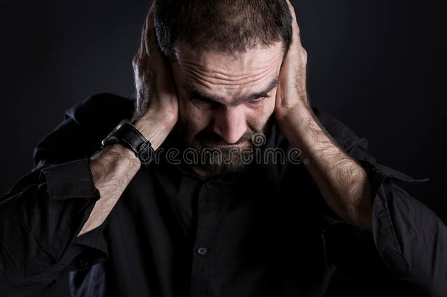 overburdened-frustrated-man-covering-ears-looking-despaired-sullen-his-down-hurt-isolated-black-background-55257374.jpg