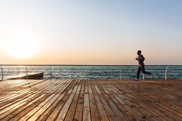 side-view-sportive-man-running-quay-near-sea_8353-6845.jpg