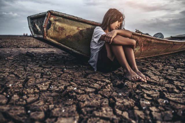 women-sitting-hugging-their-knees-bent-dry-soil-there-were-fishing-boats.jpg