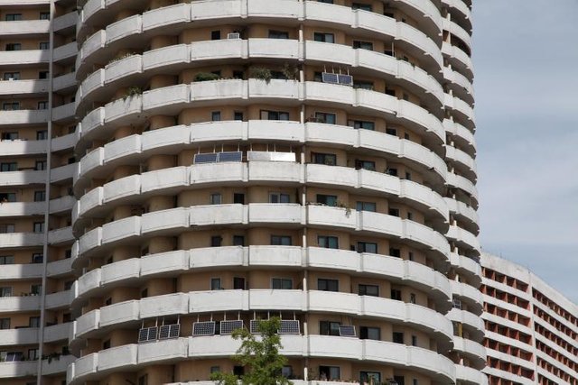 Solar panels facing the sun from balconies of an apartment building in Mangyongdae District, Pyongyang August 27, 2014. REUTERS.Staff.jpg