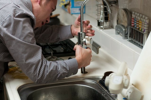 plumber working on kitchen sink.jpg