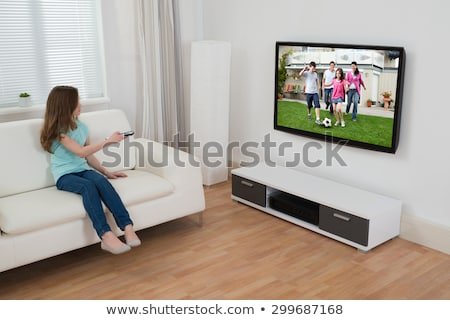 girl-sitting-on-sofa-watching-450w-299687168.jpg