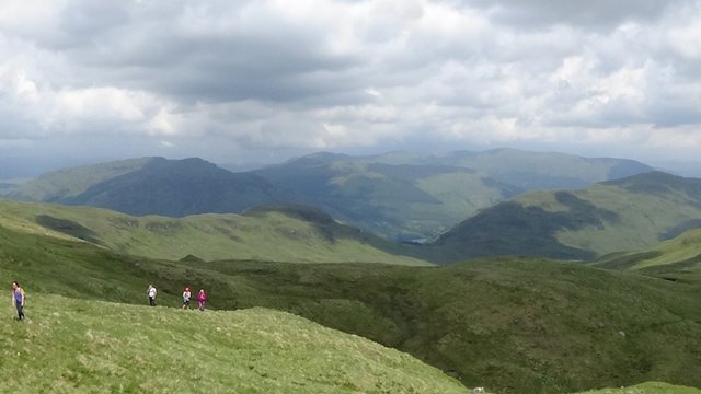 14 Group nearing summit, ominously grey clouds, Loch Voil in distance.jpg