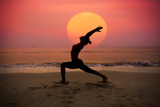 woman-practicing-yoga-with-sun-her.jpg