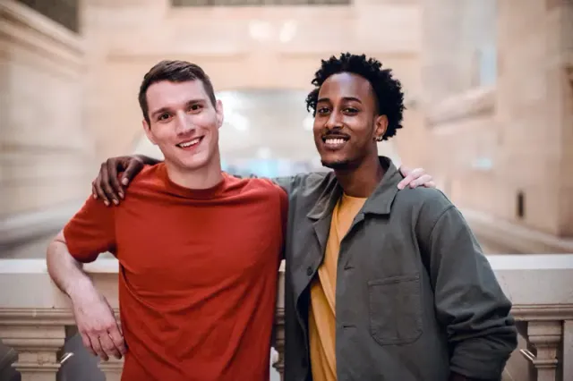 Two-guys-hug-friends.png.webp