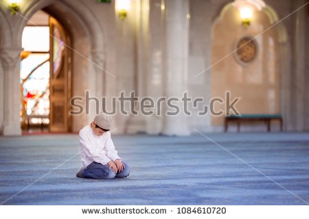 stock-photo-little-boy-in-the-mosque-read-the-quran-1084610720.jpg