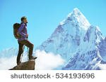 stock-photo-hiker-with-backpacks-reaches-the-summit-of-mountain-peak-success-freedom-and-happiness-534193696.jpg