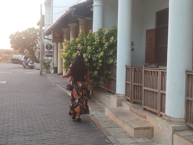 girl walking inner streets galle fort.jpg