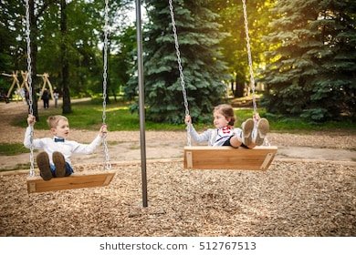 boy-girl-on-swing-children-260nw-512767513.jpg