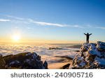 stock-photo-hiker-celebrating-success-on-top-of-a-mountain-in-a-majestic-sunrise-240905716.jpg