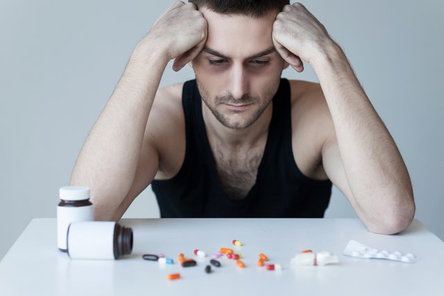 vecteezy_addicted-to-these-pills-frustrated-young-man-sitting-at-the_13540705.JPG
