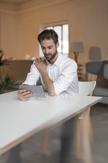 focused_165748428-stock-photo-man-sitting-at-table-and.jpg