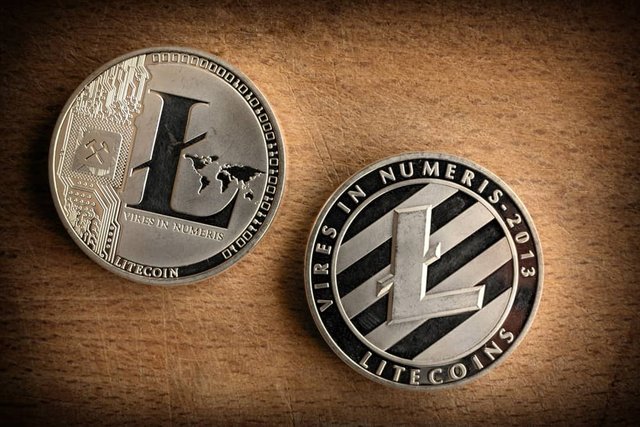 Close-up-photo-shiny-silver-litecoins-laying-on-wooden-background.-Isolated-litecoin-ltc.-Detail-Macro-photo-of-new-modern-decentralized-cryptocurrency.jpg
