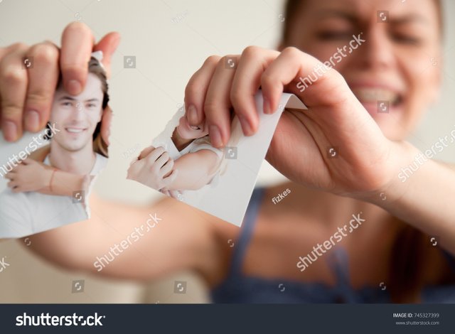 stock-photo-close-up-image-of-torn-into-two-pieces-photograph-of-happy-smiling-and-hugging-young-couple-in-745327399.jpg