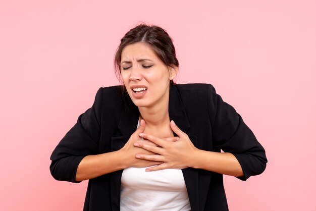 front-view-young-female-dark-jacket-suffering-from-heart-pain-pink-background_179666-14707.jpg