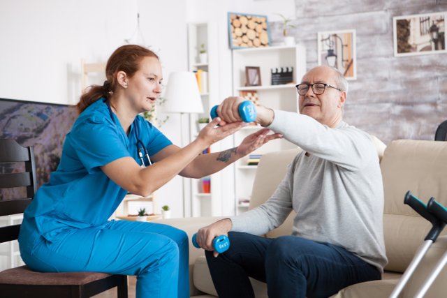 senior-man-nursing-home-with-doing-physical-therapy-with-help-from-nurse-using-dumbbells.jpg