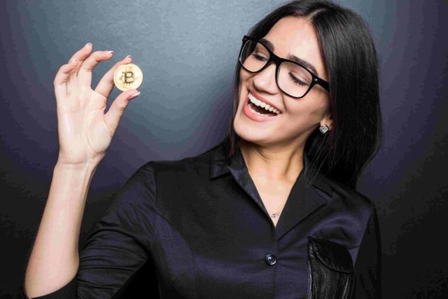 young-successful-confident-woman-with-glasses-holds-gold-bitcoin-her-hand-isolated-black-wall-1-1-768x512.jpg